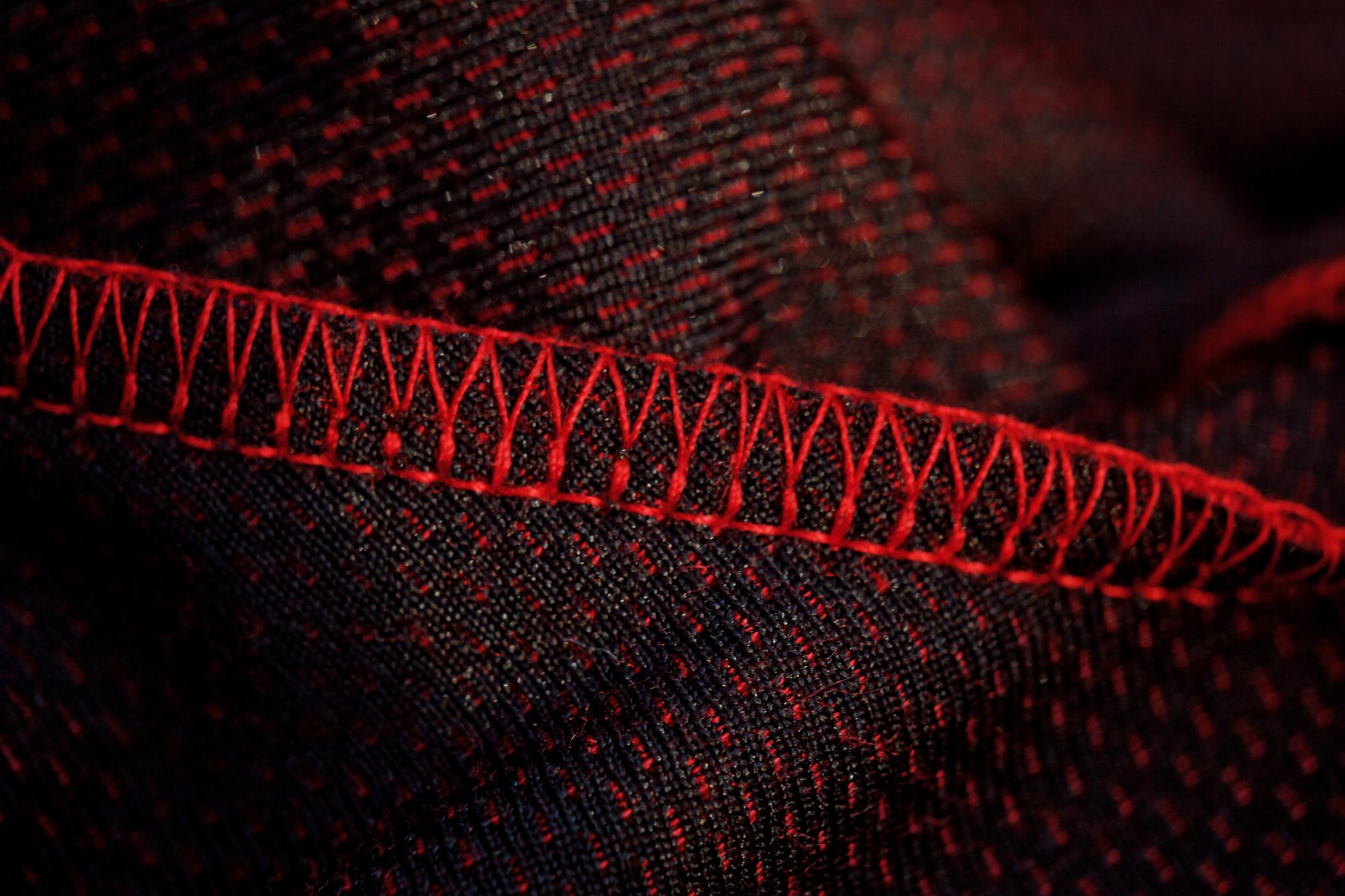 Close-up of technical embroidered pattern on dark fabric